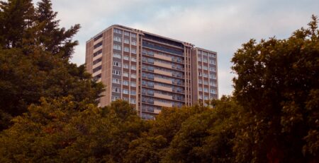 Leasehold apartment buildings and estate agent signs in the UK